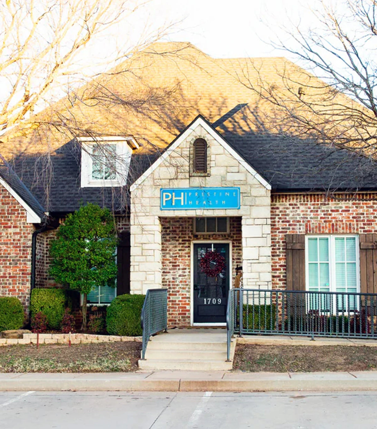 Pristine Health 33rd Street clinic exterior — brick building with PH sign and accessible 1709 entrance