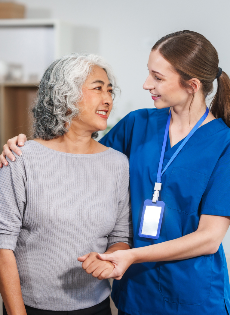 nurse and patient smiling at one another